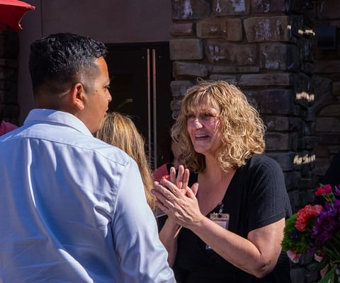 Residents and staff engaged in conversation at an event