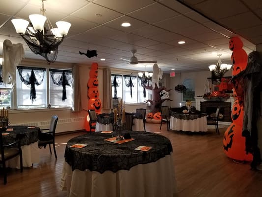 Interior decorated for a Halloween celebration with tables and decorations