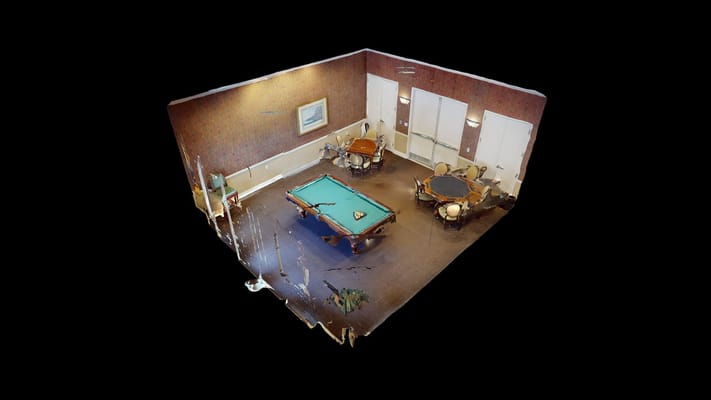 Interior view of a game room with pool table and tables