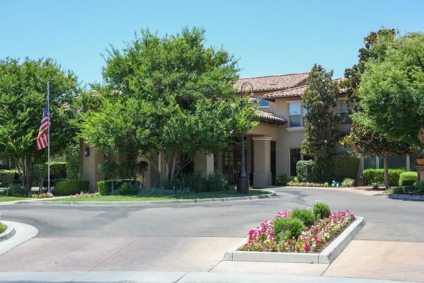 Exterior view of the Oakmont of Fresno facility with landscaping