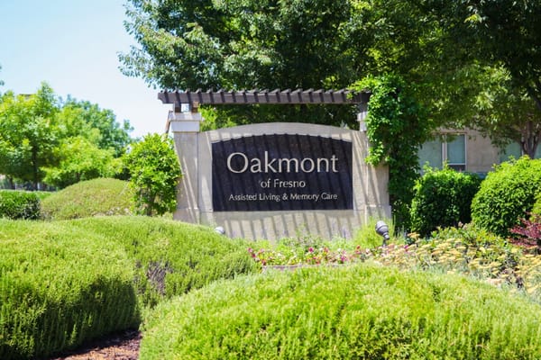 Signage for Oakmont of Fresno with landscaped gardens