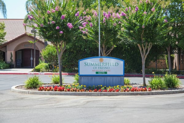 Entrance sign for Summerfield of Fresno surrounded by landscaping