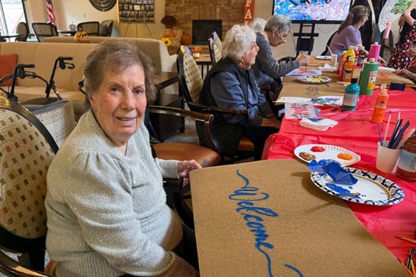 Residents participating in a decorative activity indoors