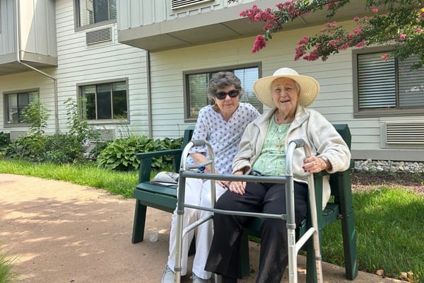 Residents enjoying time outdoors on a bench
