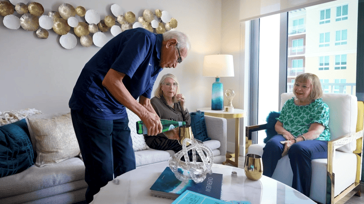 Resident enjoying time with staff in a common area
