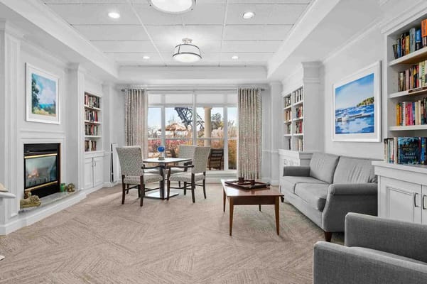 Bright and inviting common area with seating and bookshelves
