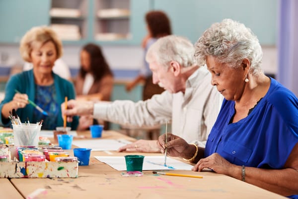 Residents enjoying a painting activity in a common area
