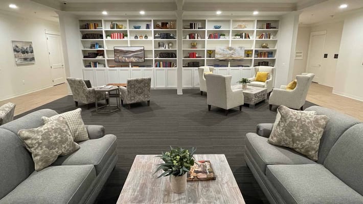 A cozy common area with seating and bookshelves
