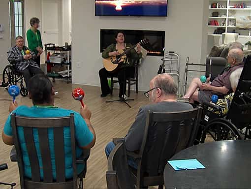 Residents participating in a music activity in a common area