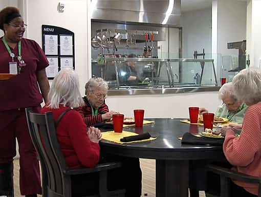 Residents enjoying meals in a dining room setting