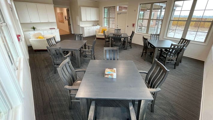 Bright common area with dining tables and chairs