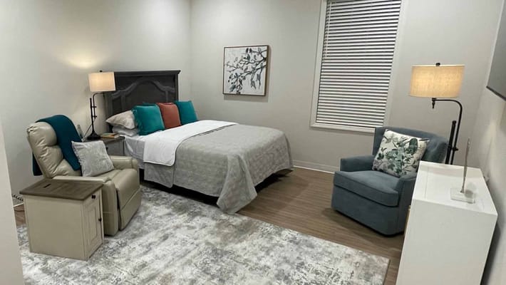 Private resident room with bed and seating area