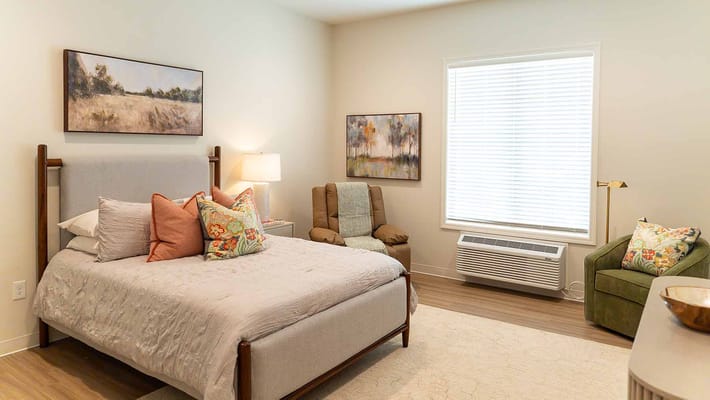 Cozy resident room with bed and artwork