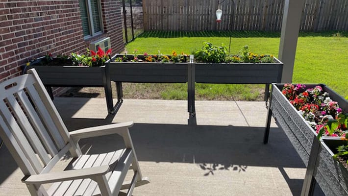 Outdoor garden area with planters and a chair