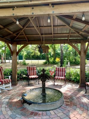 Outdoor seating area with fountain and garden