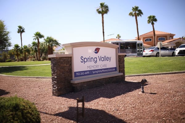 Signage for Spring Valley Memory Care with palm trees