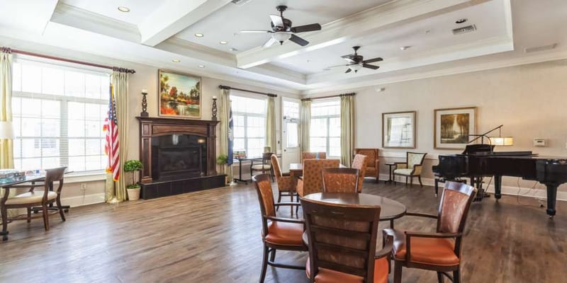 Bright common area with seating and a piano