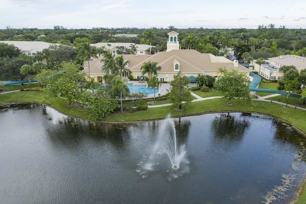 Aerial view of a senior living facility by a pond