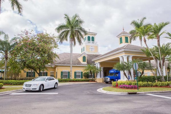 Exterior view of a senior living facility with palm trees
