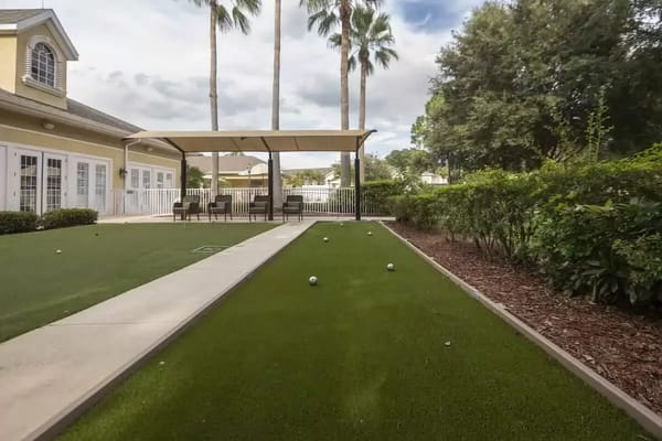 Outdoor area with a bocce ball court and shaded seating