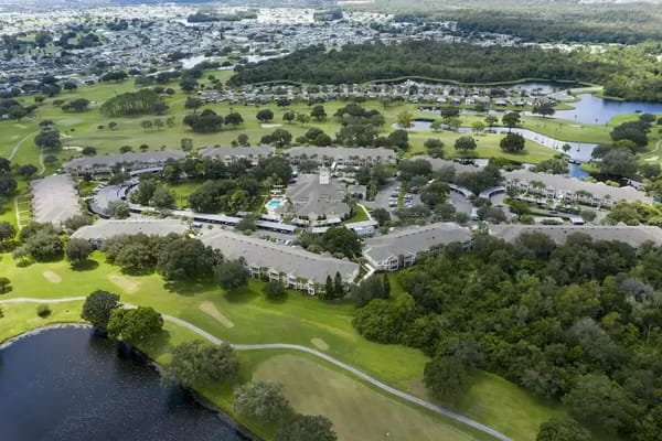 Aerial view of a senior living community surrounded by greenery