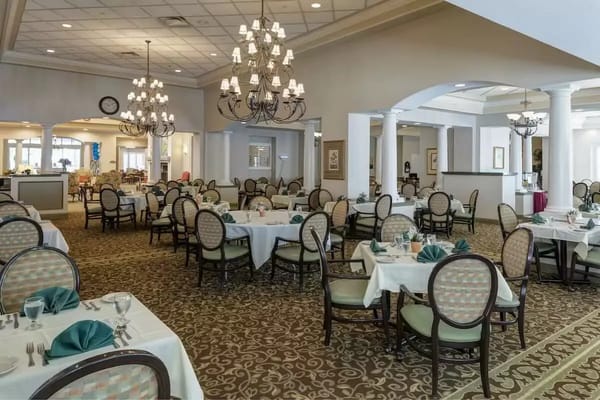Elegant dining room setup with tables and chandeliers