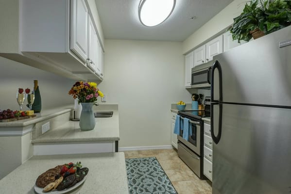 Well-equipped kitchen with fresh flowers and food