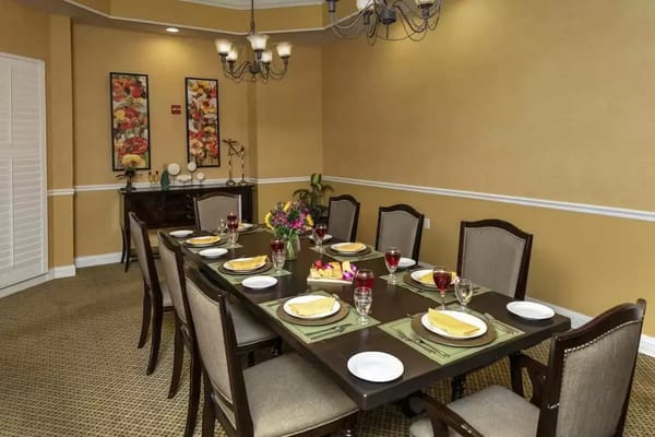 Dining area set with plates and flowers