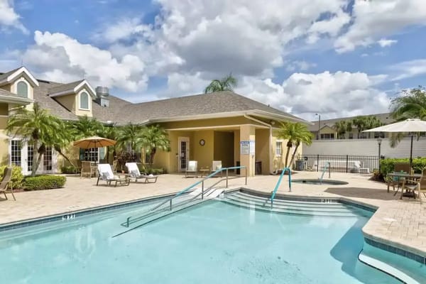 Outdoor swimming pool area with lounge chairs