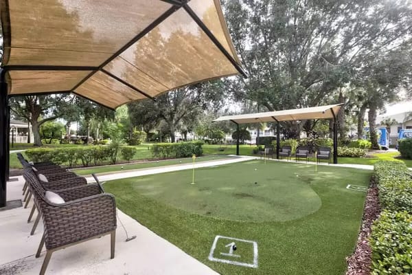 Outdoor putting green area with seating