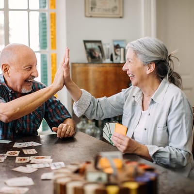 Residents enjoying a card game at a table