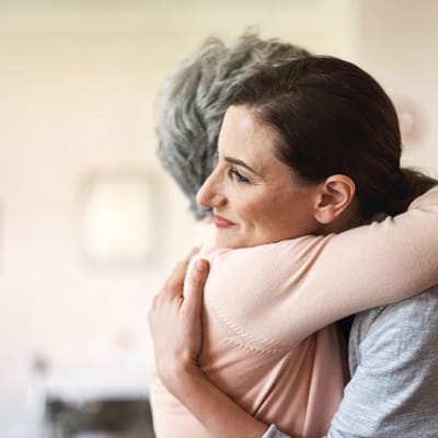 Staff member embracing a resident in a warm scene