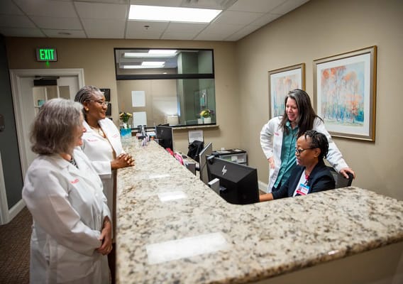 Staff assisting at the reception area in a healthcare facility