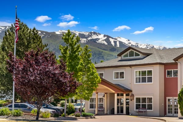Front entrance of assisted living facility with mountains in background