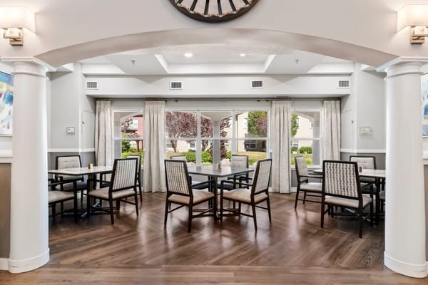 Dining area with tables and chairs in a bright space