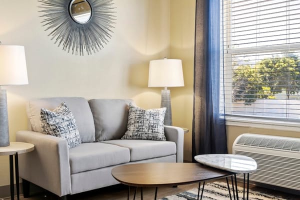 Cozy living room setup with sofa and decorative mirror