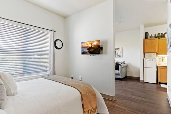 Cozy resident room with warm decor and kitchen area