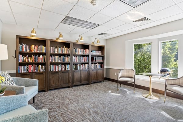 Bright interior common area with bookshelves and seating