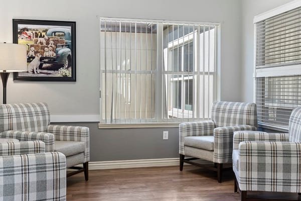 Comfortable seating area with plaid chairs and artwork