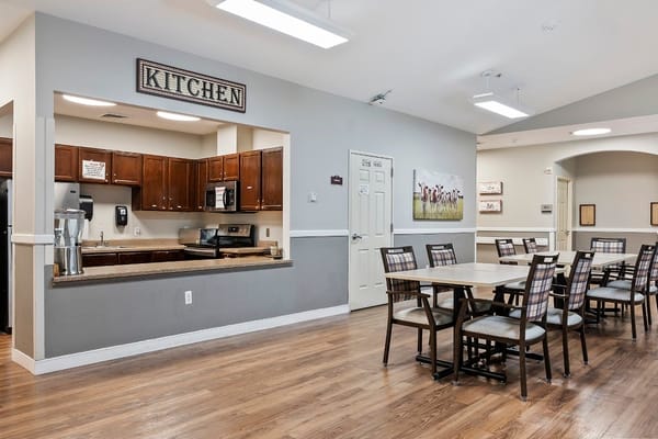 Bright common area with kitchen and dining setup