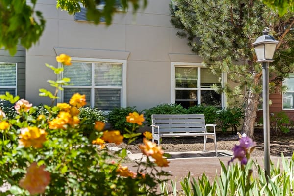 Outdoor seating area with flowers near the facility