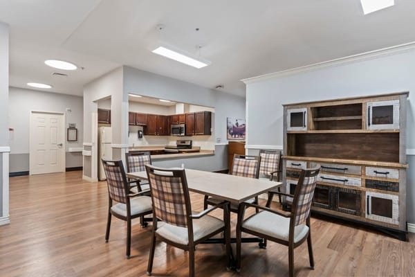 Interior view of a dining room with a wooden table and chairs