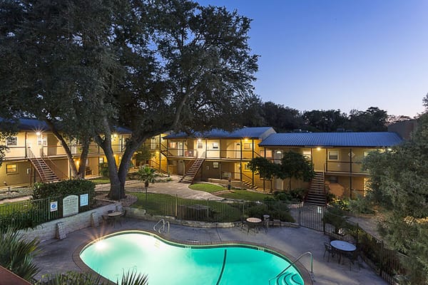 Swimming pool with surrounding outdoor lounge area and building