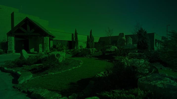 Entrance of Liberty Park Senior Living with landscaped outdoor space