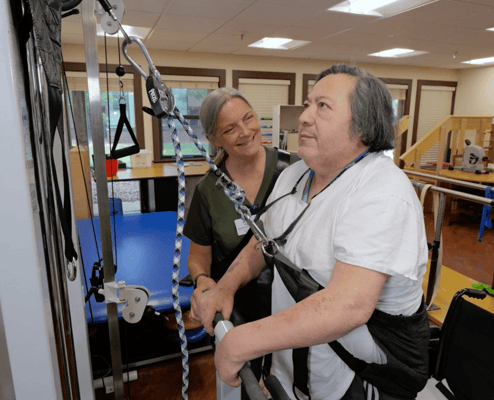 Staff assisting a resident during therapy