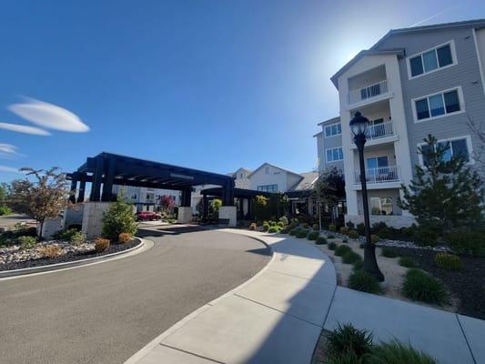 The entrance of Revel Rancharrah senior living facility with landscaped surroundings.