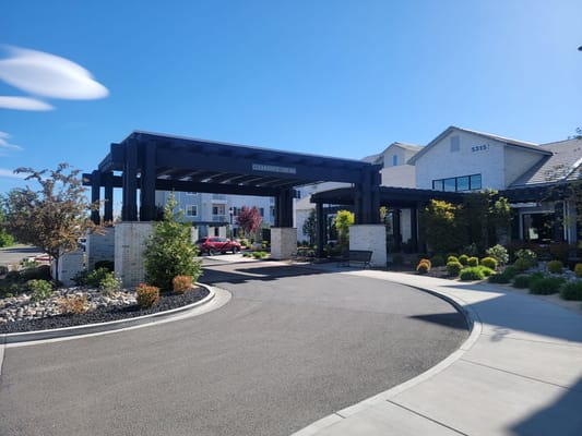 Main entrance with a covered canopy at Revel Rancharrah senior living facility
