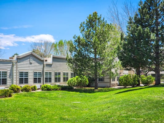 Exterior view of assisted living facility with green landscaping