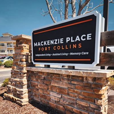 Sign for Mackenzie Place in Fort Collins, showcasing independent living, assisted living, and memory care services.