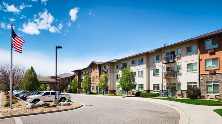 Exterior view of a senior living facility with landscaping